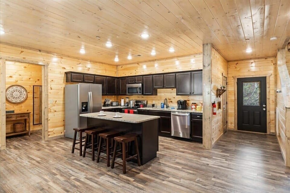 Enjoy the full kitchen with refrigerator, oven, stove, microwave, dishwasher, coffee, creamers, mixers, spices, pots, pans, cooking supplies, cutlery, cups, plates, bowls, utensils, small appliances, and many more essentials.