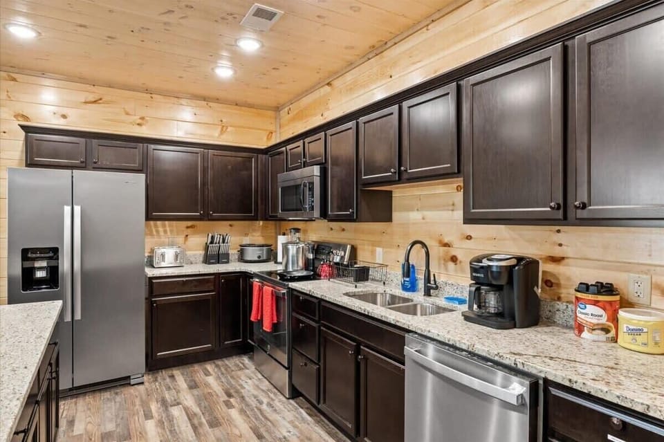 Enjoy the full kitchen with refrigerator, oven, stove, microwave, dishwasher, coffee, creamers, mixers, spices, pots, pans, cooking supplies, cutlery, cups, plates, bowls, utensils, small appliances, and many more essentials.
