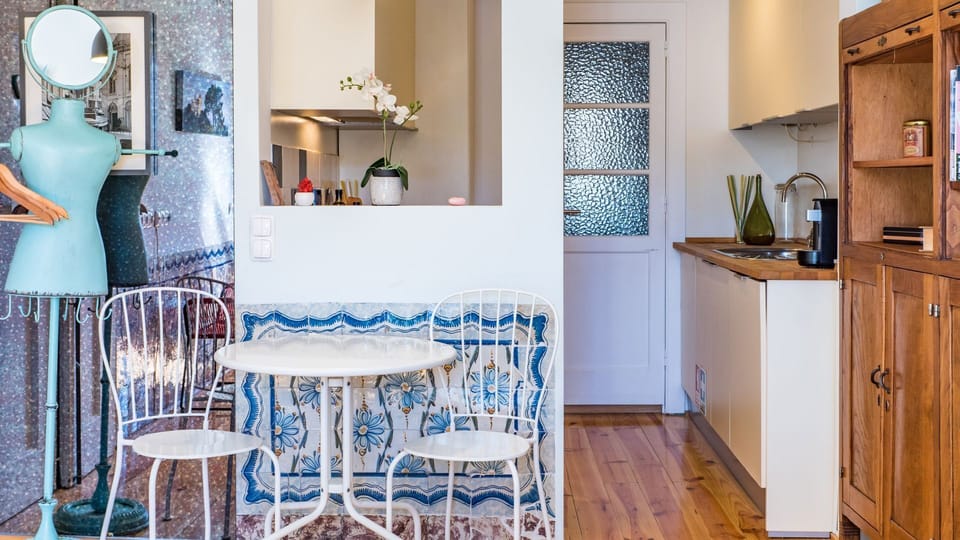 A charming dining nook framed by traditional Portuguese tiles and artistic touches. The perfect spot for breakfast before exploring the city. #PortugueseDesign #CozyLiving #LisbonApartment #TravelPortugal #Portugal #PT #Lisbon