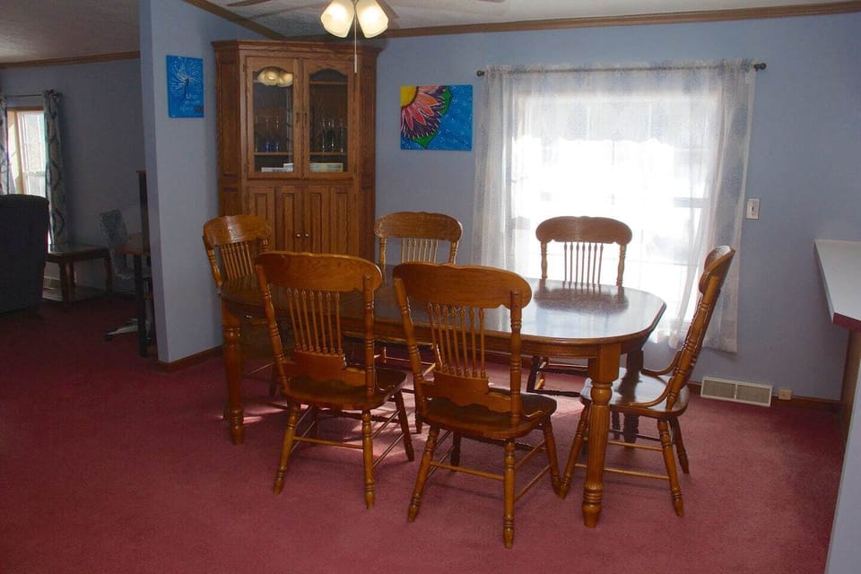 Large dining table with 6 chairs. More chairs in bedroom closet.