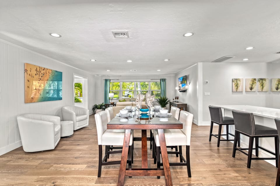 From the dining table, look straight out through the sliding glass doors to the expansive lanai and sparkling pool, bringing the outdoors in.