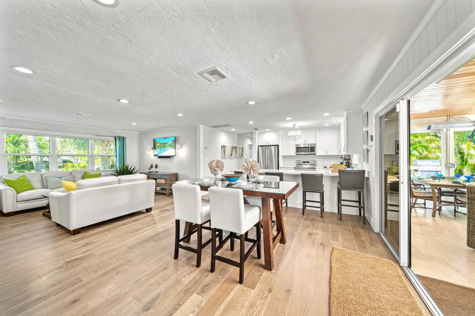 Envision delightful meals at the dining table, with the warm, open-concept living room and fully equipped kitchen seamlessly blending behind you.