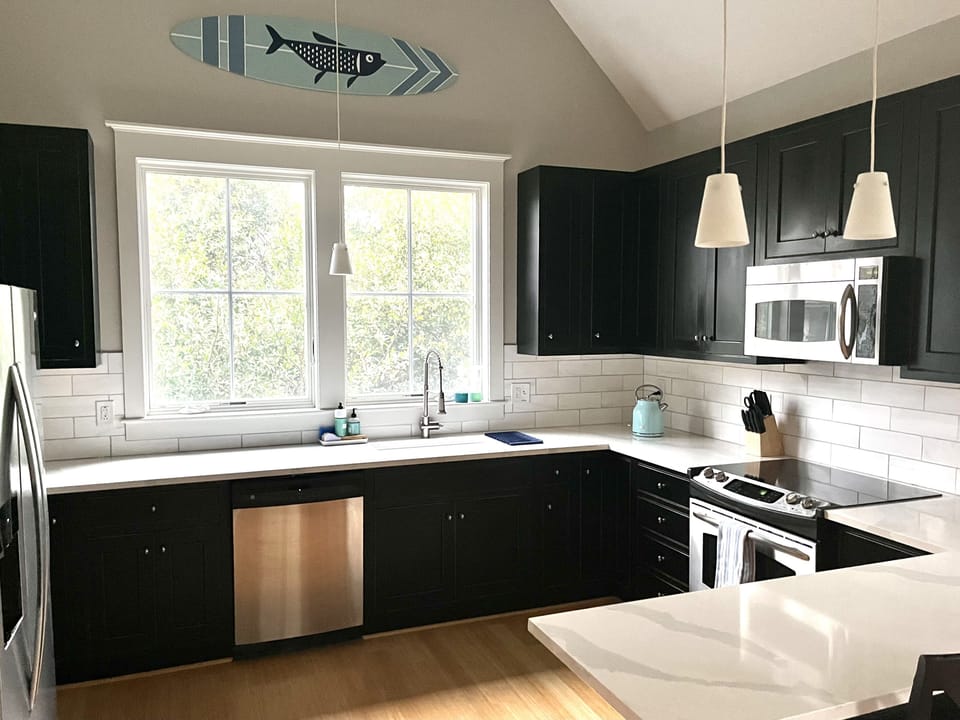 Large kitchen with new quartz counters, marble backsplash. Kitchen bar seats 2.