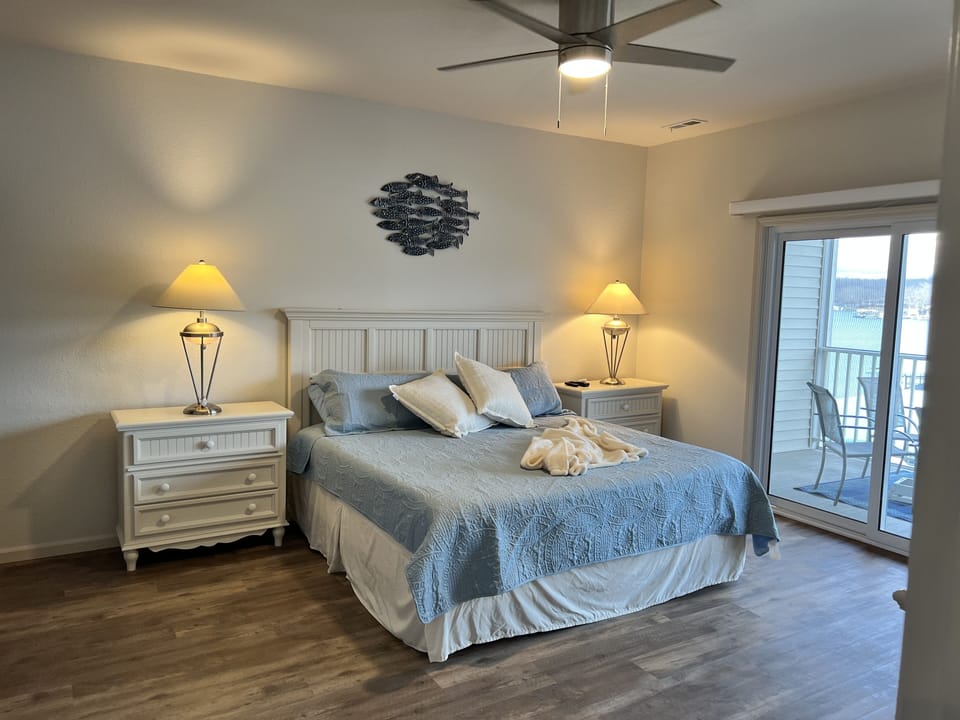 MBR has a king bed, TV, fan, full length mirror,  walk-in closet, balcony access
