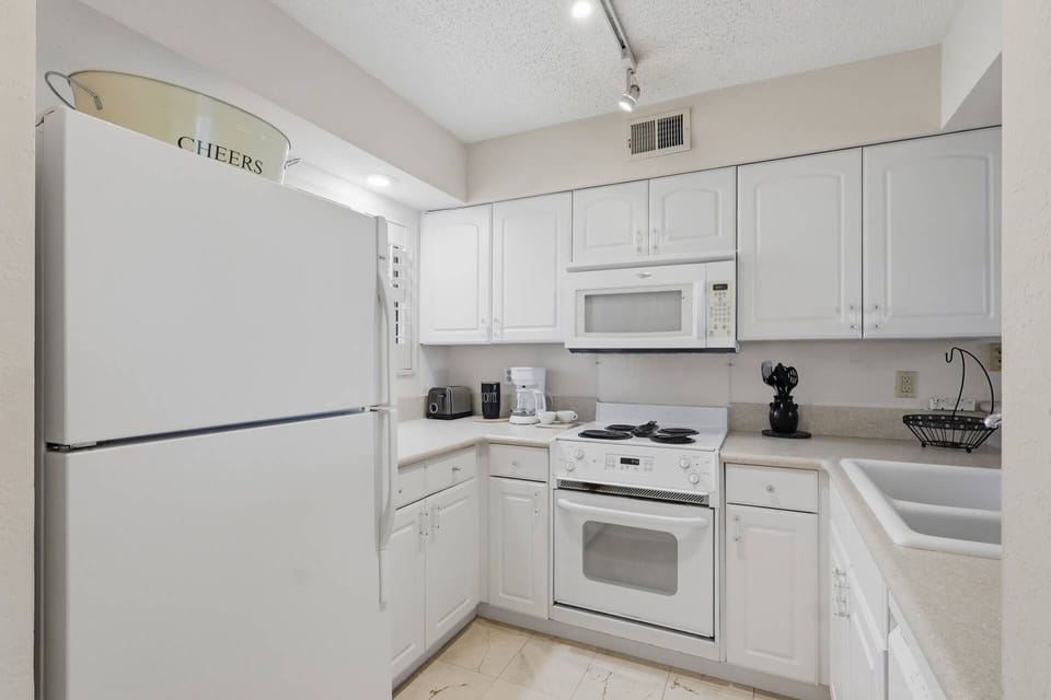 Fully equipped kitchen stocked for easy vacation meals & morning coffee