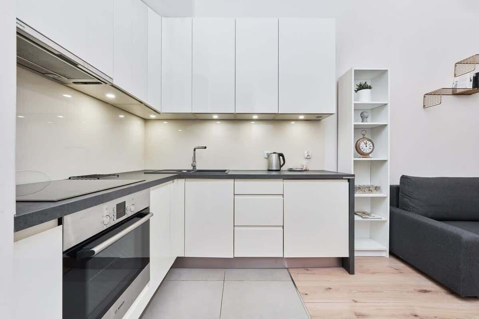 The sleek design of the kitchenette blending seamlessly with the living area.