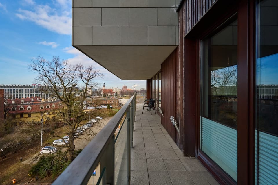 Balcony space with seating for enjoying city views.
