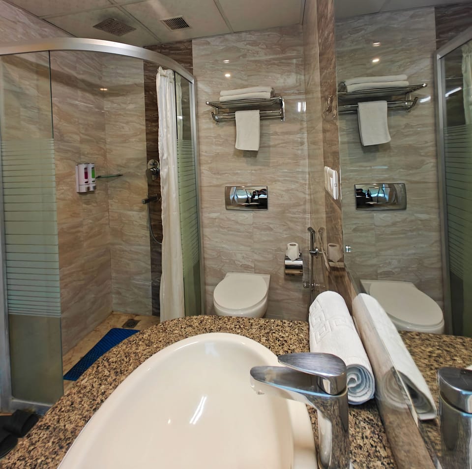 Shower, eco-friendly toiletries, slippers, towels