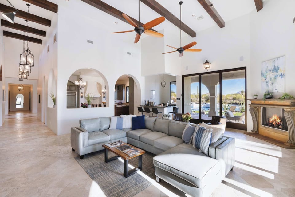 Soaring ceilings with exposed beams, elegant archways, and walls of glass.