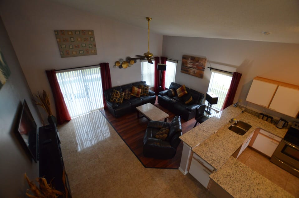 Living room with leather sofa's and 60 inch TV mounted on the wall