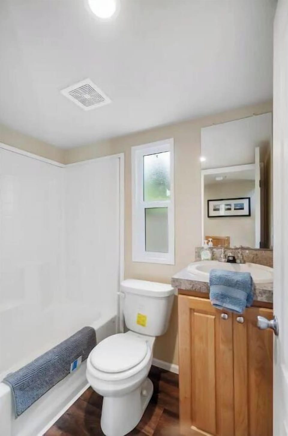 Bathroom with tub/shower,  hair dryer, essentials, and fresh towels provided.
