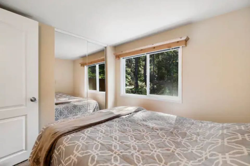 Main floor bedroom with plush bedding and natural light