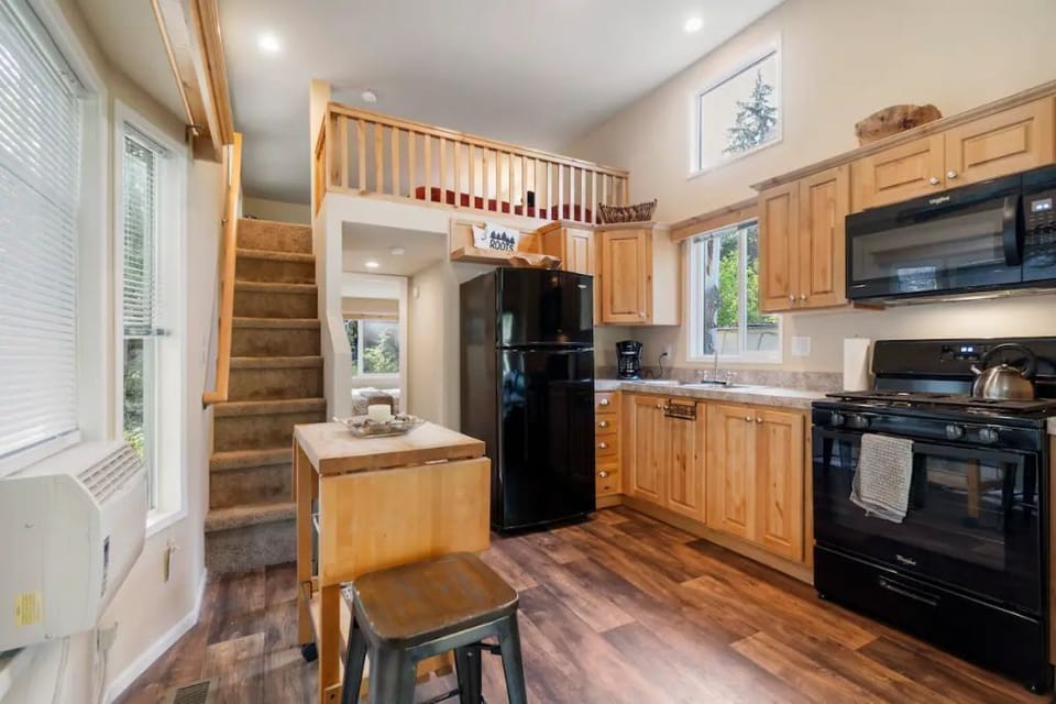 Open kitchen layout with stair access to loft