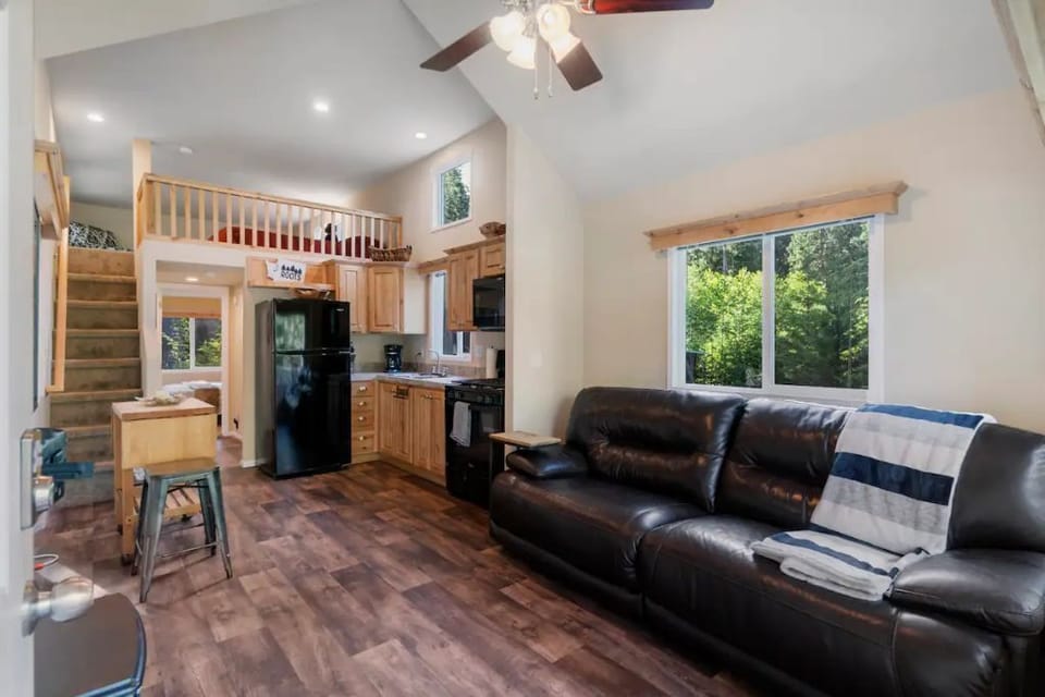 Open living space with TV, seating, and natural light