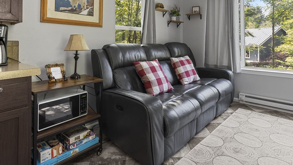 Cozy living room with leather seating and cabin accents