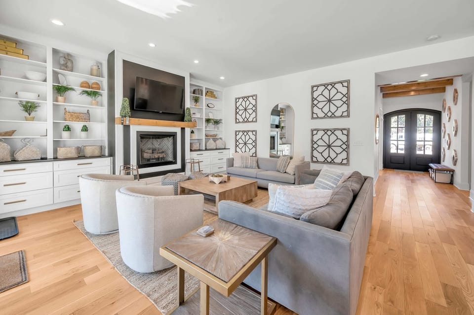 Cozy up by the fire in this beautiful open concept living room, perfect for spending quality time with loved ones during your stay.