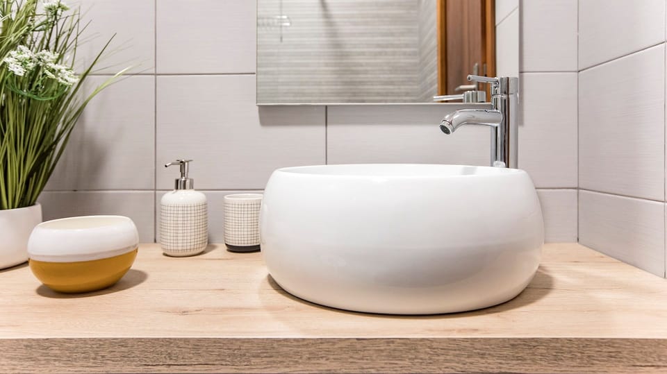 Modern design meets functionality at this stylish bathroom vanity, complete with a contemporary basin and fresh greenery.
#Bathroom #ModernDesign #LovelyStay