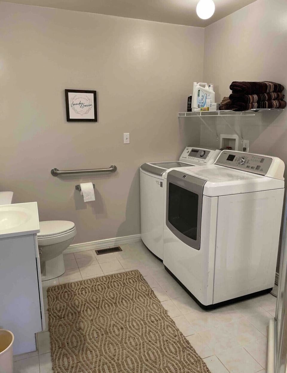 The third bathroom features a corner shower and laundry facilities