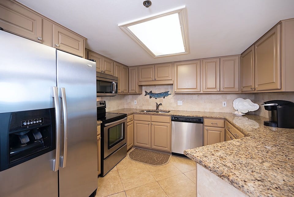 The kitchen features stainless steel appliances and granite countertops