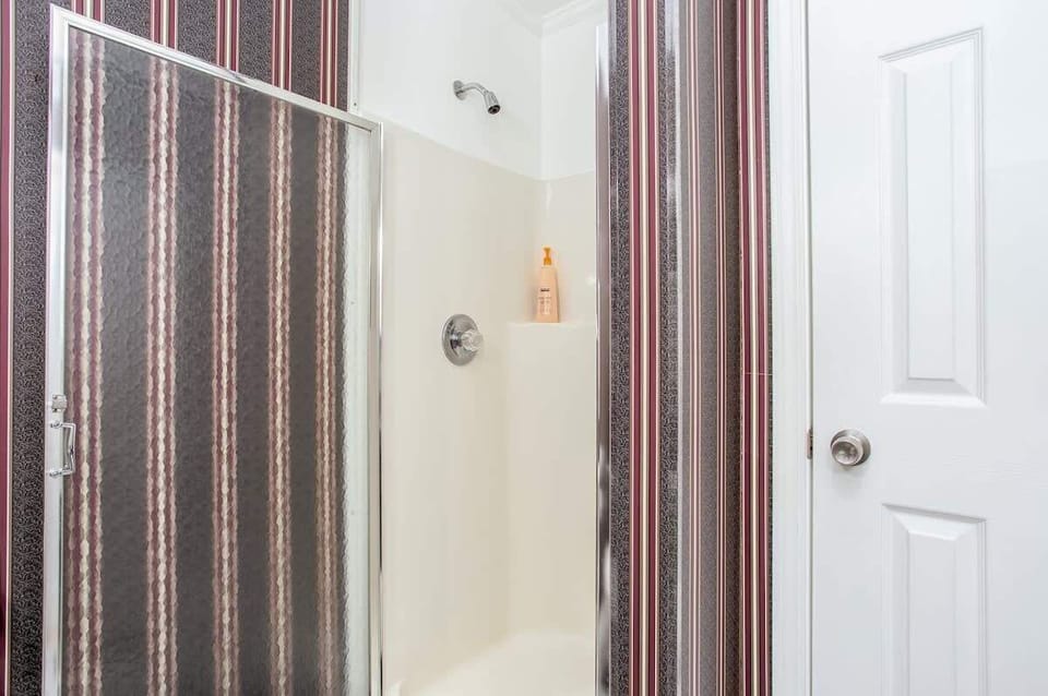 Shower with linen closet.