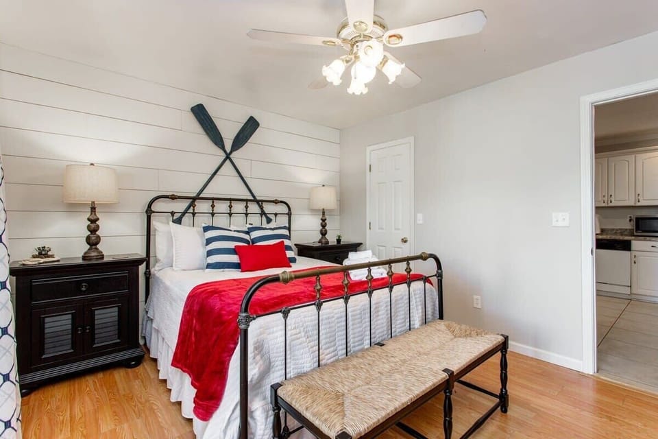 Nice sized closet in corner and sitting bench in front of queen bed.