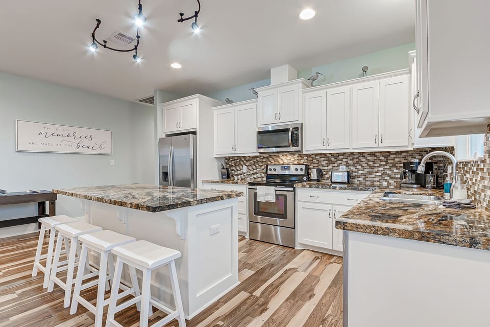 The fully stocked kitchen features seating for four at the island. 
