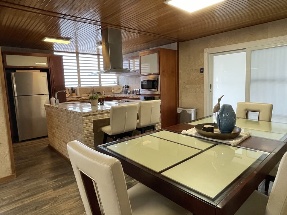 Kitchen and dining areas with direct access to side and back yard