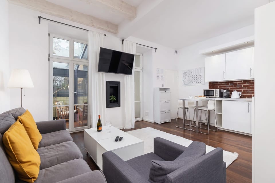 Bright living area with a stylish sofa and large windows.
