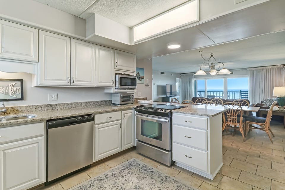Newly Remodeled Kitchen with Granite Countertops, Stainless Steel Appliances, and Bar Stool Seating for 3