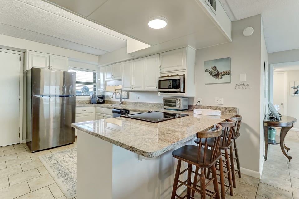 Newly Remodeled Kitchen with Granite Countertops, Stainless Steel Appliances, and Bar Stool Seating for 3