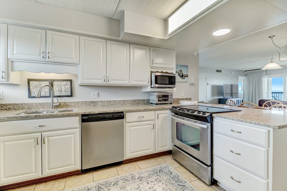 Newly Remodeled Kitchen with Granite Countertops, Stainless Steel Appliances, and Bar Stool Seating for 3