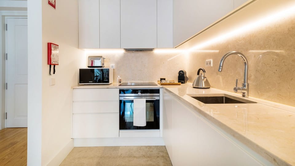 A sleek, fully equipped kitchen with premium finishes, perfect for preparing anything from a quick coffee to a homemade meal. #ModernKitchen #FullyEquipped #HomeAwayFromHome #ShortTermRental #Portugal #PT #Lisbon