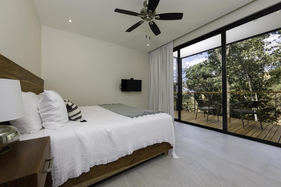 Master bedroom with sliding glass doors to the balcony.