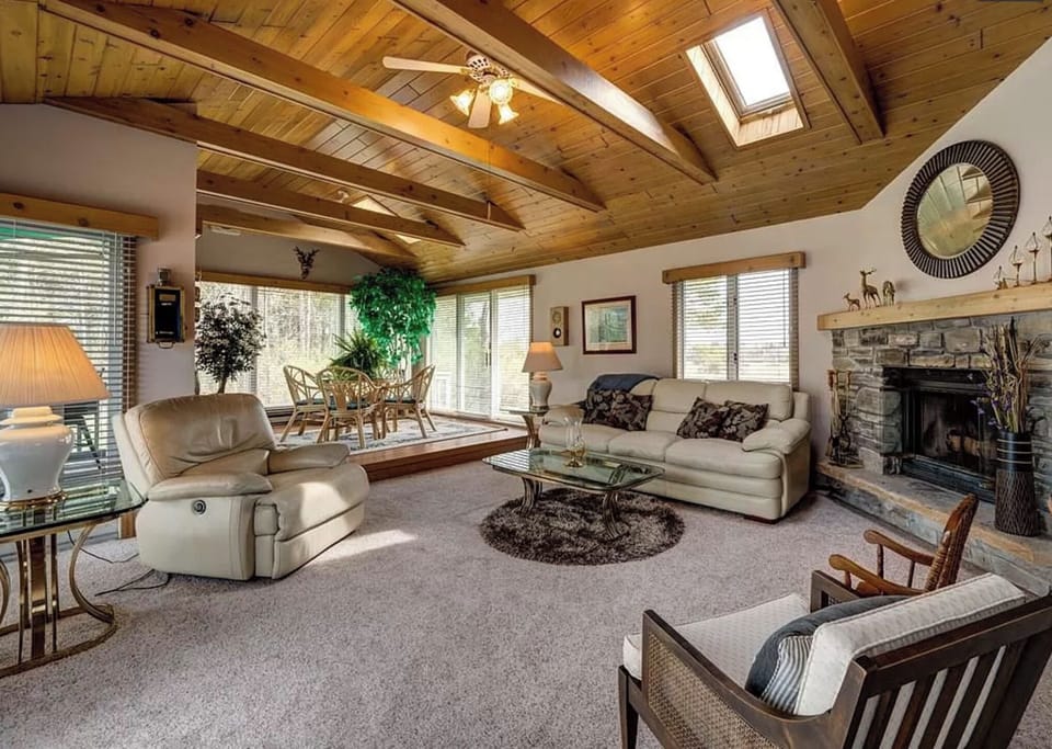 Entertainment Room/Porch room with fireplace, games, and TV.
