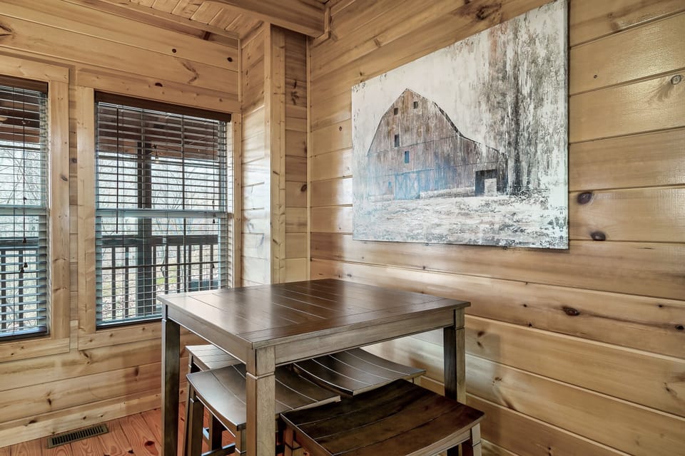 - Small cabin dining nook with wood table and peaceful window views   - Relaxing spot for morning coffee or quiet meals during mountain stays   - Warm rustic decor adds charm to your Smoky Mountain cabin retreat