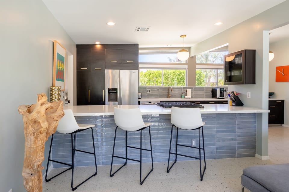 Sit and relax with your drink of choice while keeping the chef company.