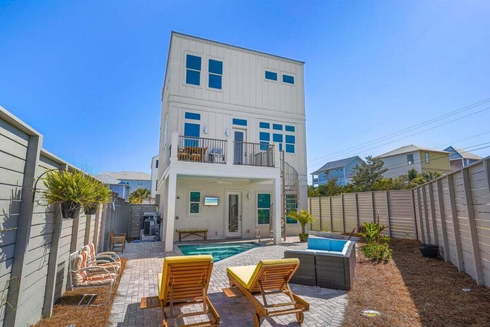 Back of the home with private fenced area and Pool