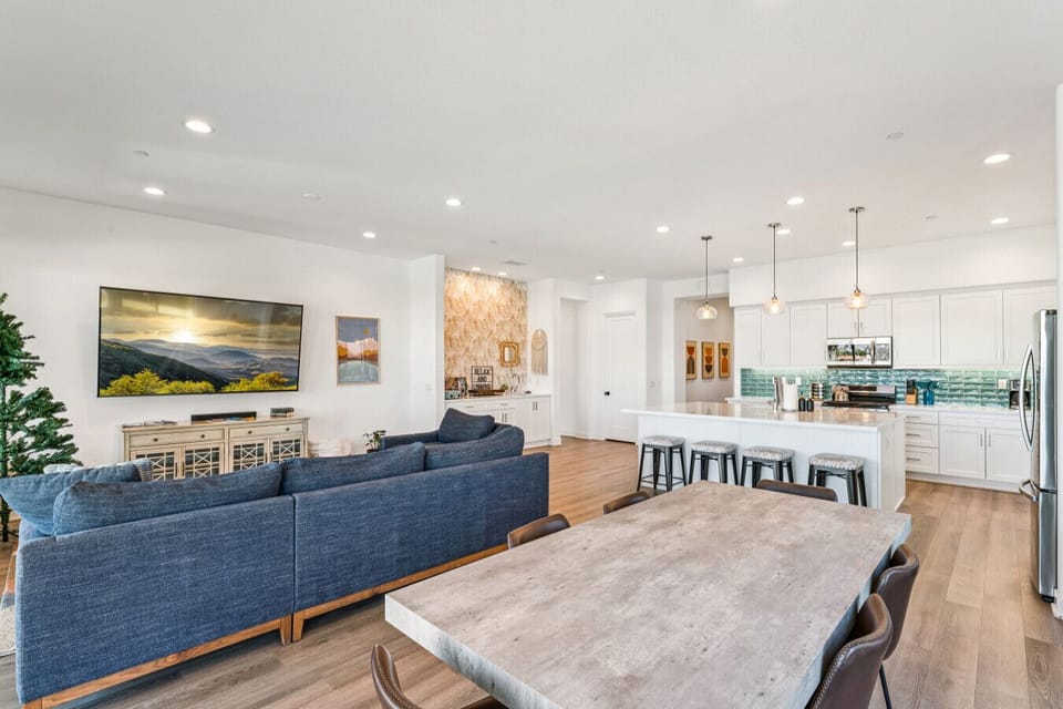 Open-concept living area w/ plush seating, dining space & seamless flow into the kitchen