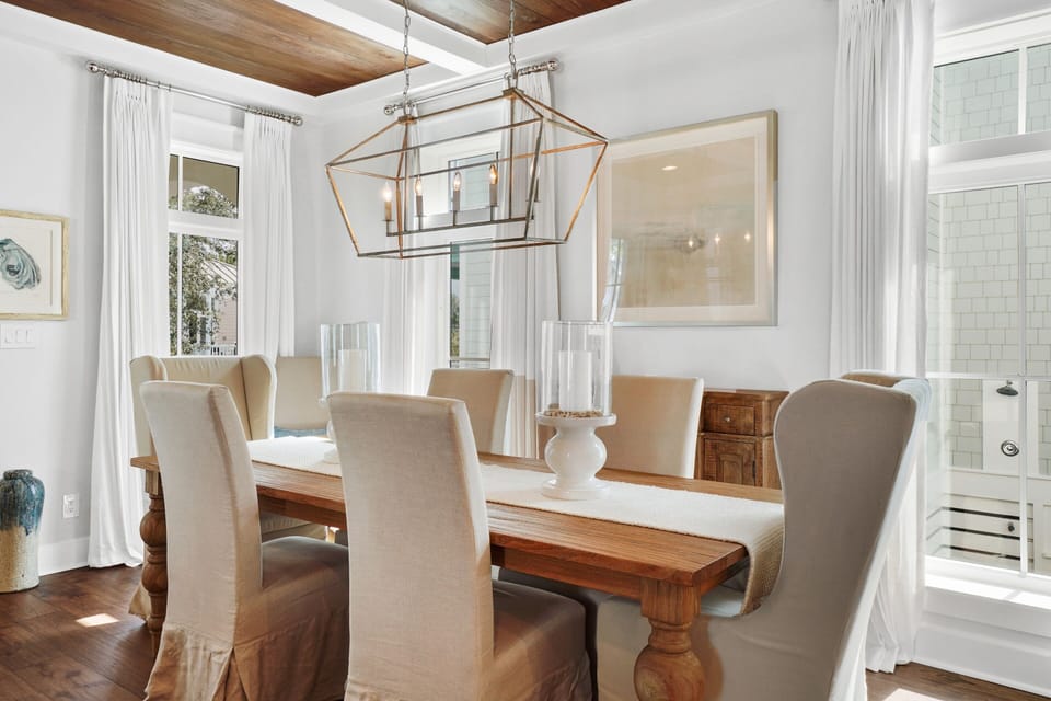 Gather around the elegant dining table where warm wood meets crisp linens, creating the perfect setting for memorable meals together.