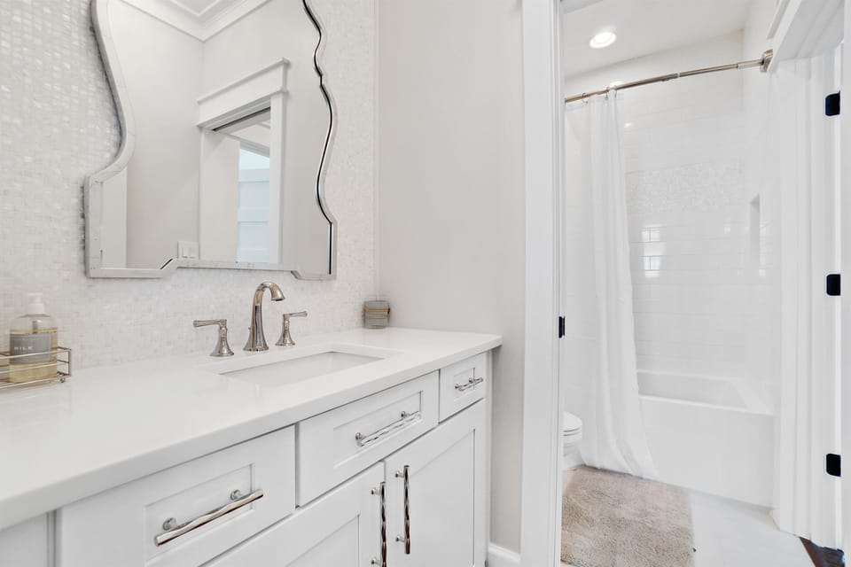 Step into your pristine bathroom sanctuary with elegant marble countertops, stylish fixtures, and a relaxing tub-shower combo for unwinding after your adventures.