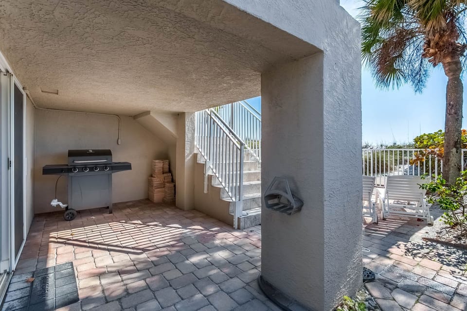 Ground floor below kitchen balcony. Room to left holds beach toys, dry bar, helf bath.