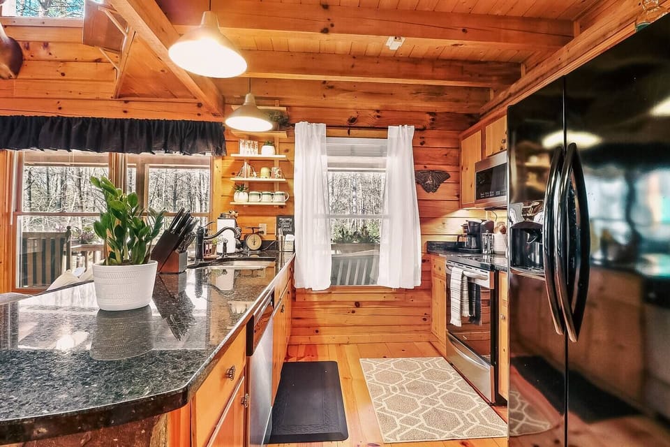 Well supplied kitchen with stainless appliances, quartz counters and an quick heat electric stovetop. Also supplied is a starter supply of dish detergent pods, cleaning supplies and trash bags for your convenience. 
