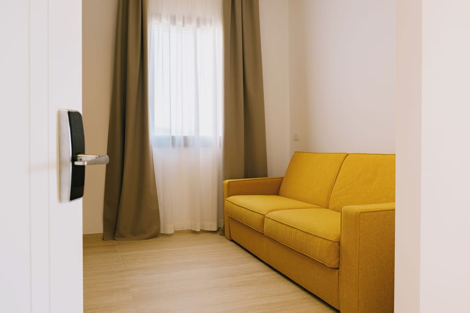 Family Room, Sea View (3 people) | Living area | Flat-screen TV