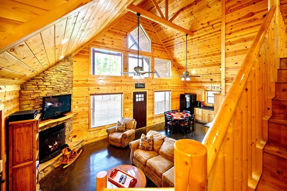 Soaring ceilings, warm wood, and a beautiful stone fireplace.