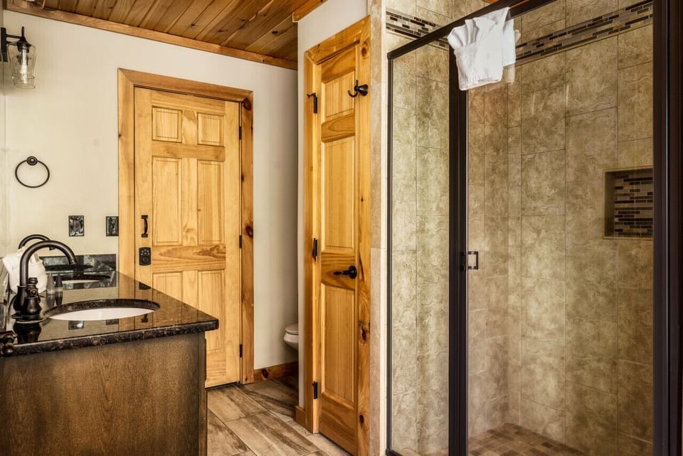 Main level king bedroom en-suite bathroom with a jacuzzi tub and walk in shower
