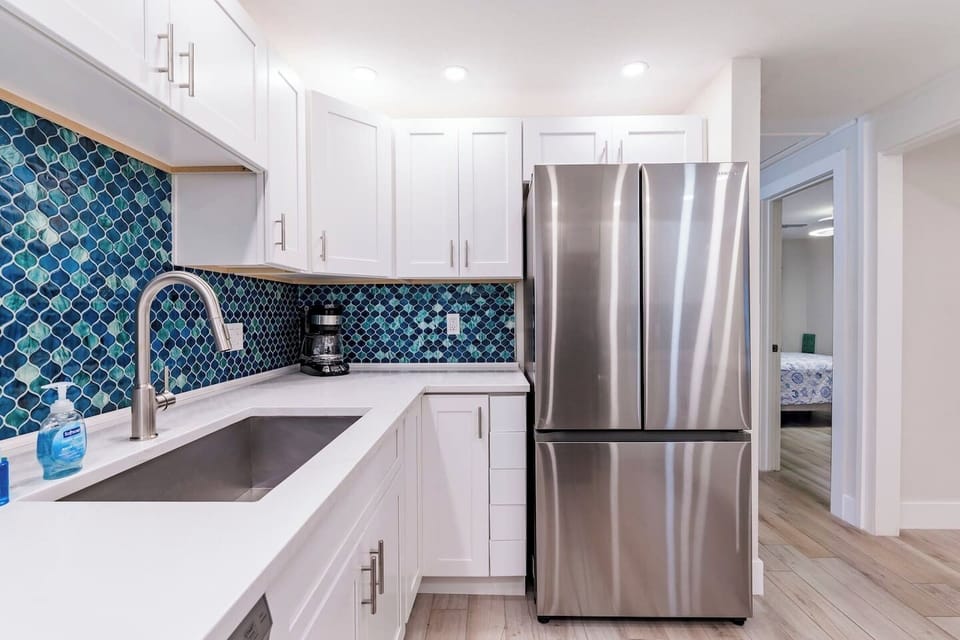 Kitchen Oasis: Bright and airy space with stylish tiles and modern appliances for culinary adventures!