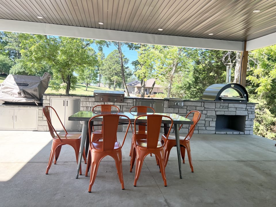 Professional outdoor kitchen with brick pizza oven.  