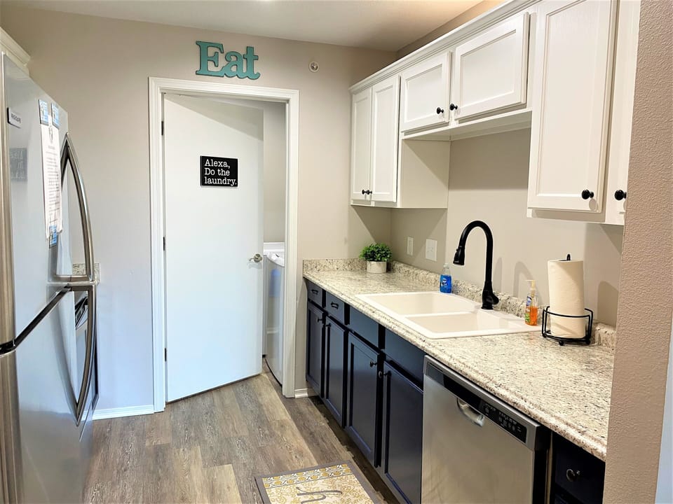 Newly remodeled kitchen leads to laundry room with a washer and dryer