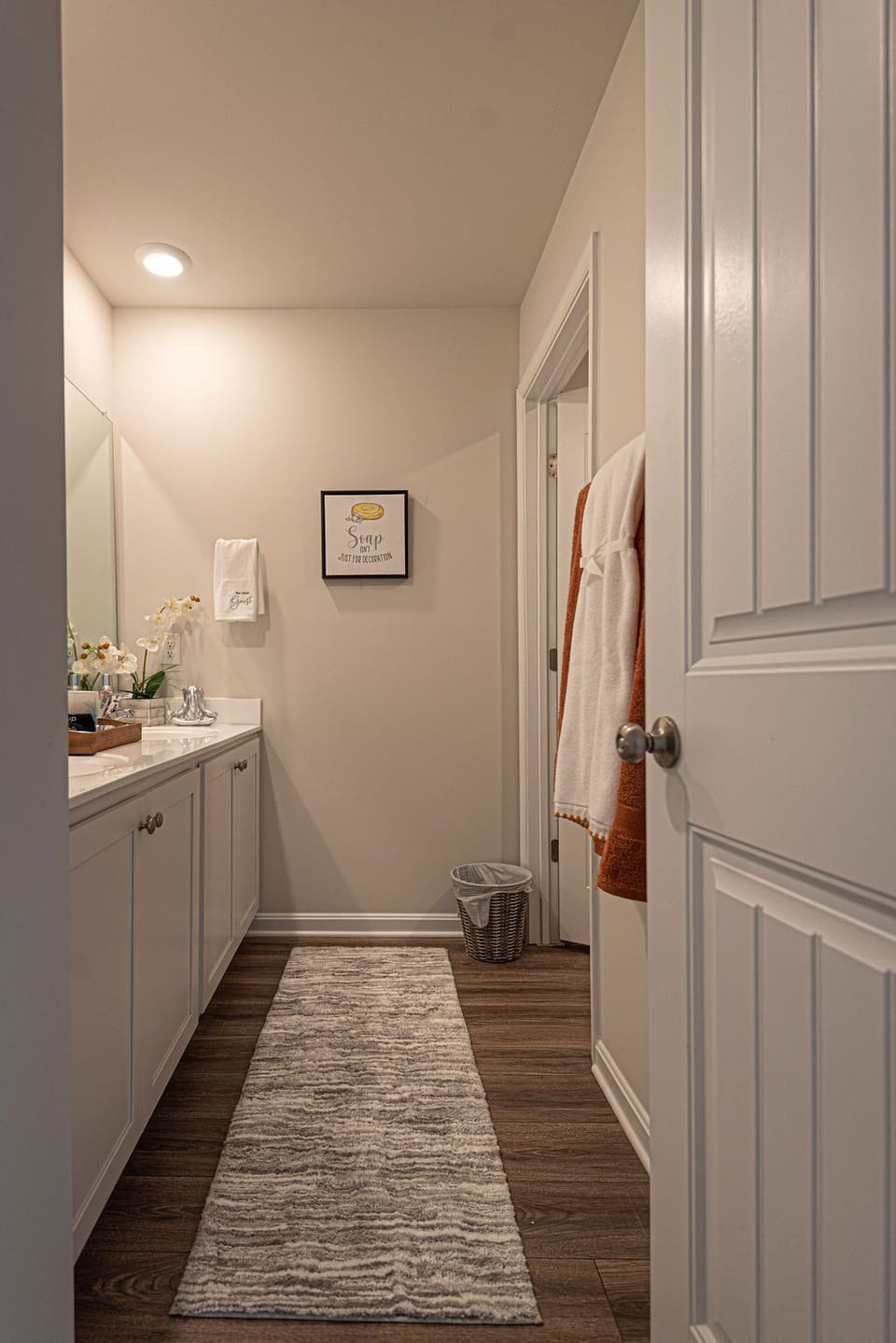Guest Bathroom with double sink, towels, trashcan, make up towel, bath towel
