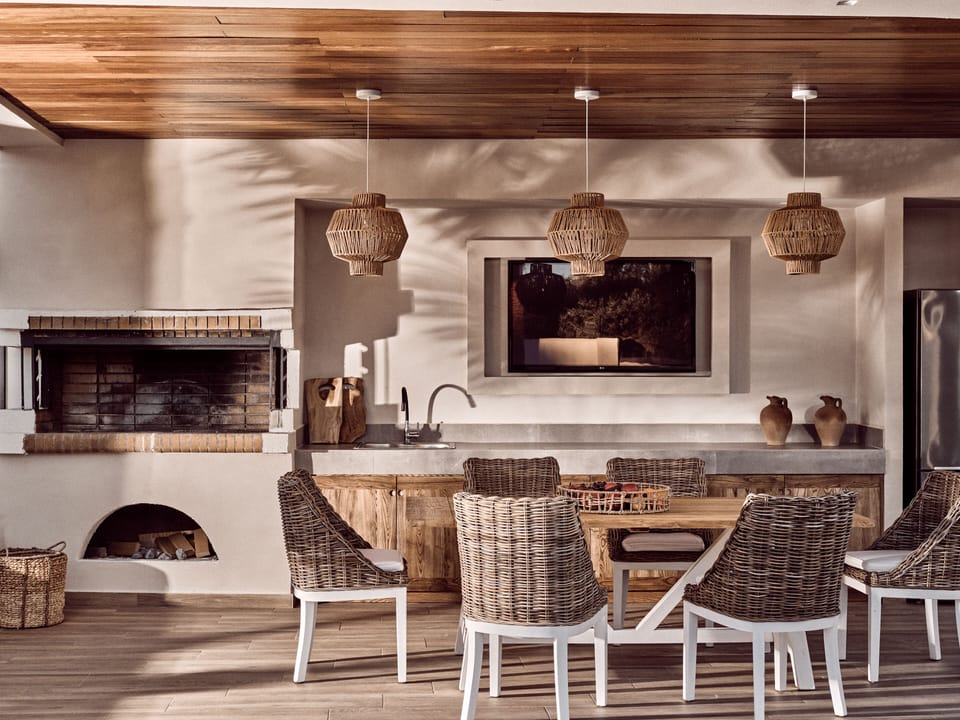 A fully equipped outdoor dinning area next to the pool with BBQ (charcoal).